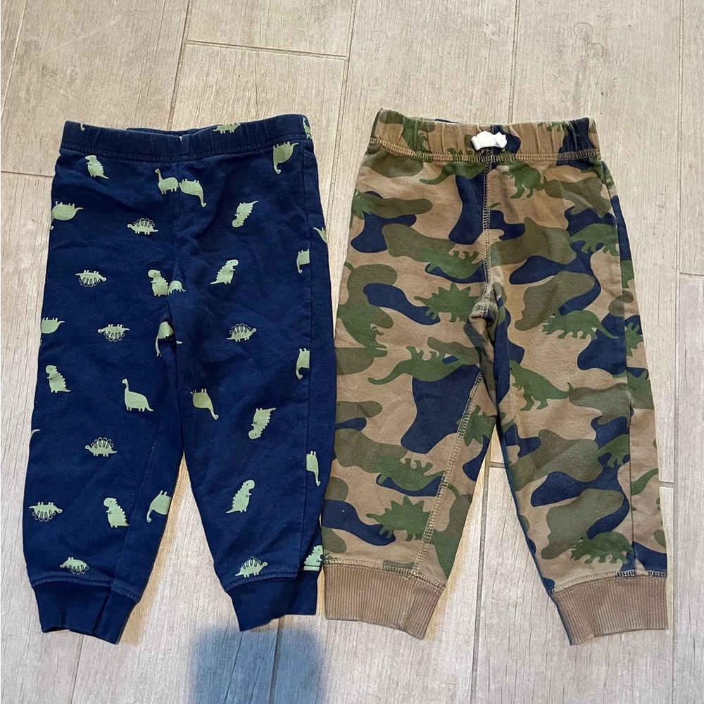 Two pair of boys pants adorned with dinosaurs. Carters size 18 month.